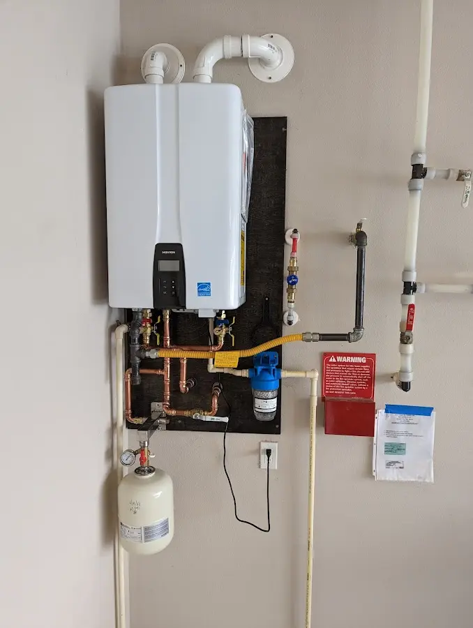 Professional plumber installing copper piping in a West Springfield home